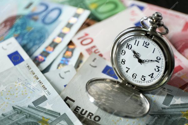 time-is-money-concept-with-pocket-watch-euros-bills-closeup_392895-304070